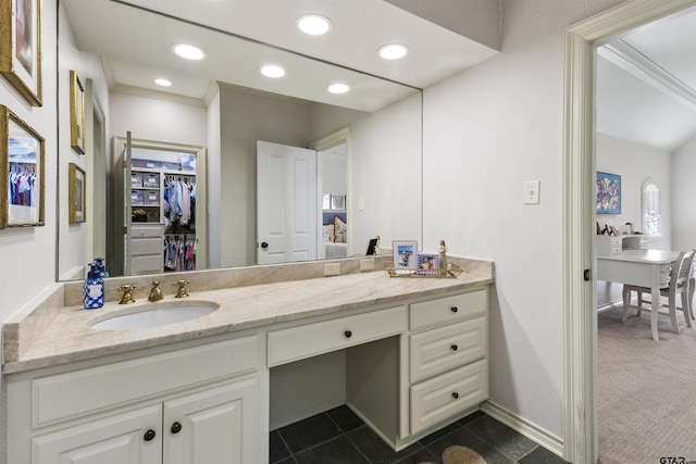 bathroom featuring crown molding, tile patterned floors, and vanity