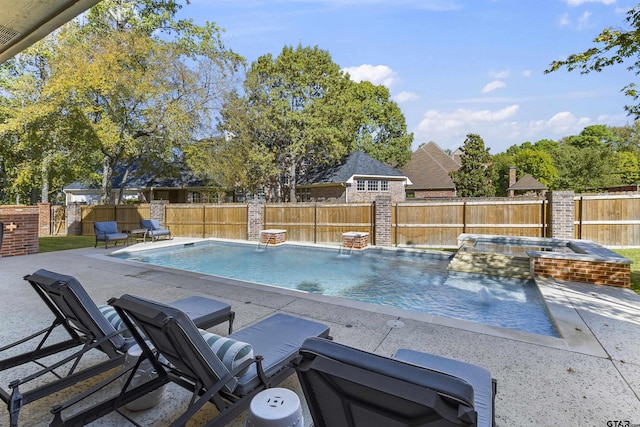 view of swimming pool featuring an in ground hot tub, pool water feature, and a patio