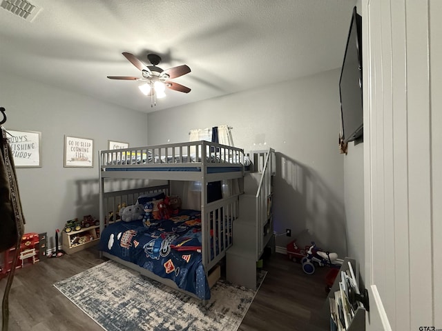 bedroom featuring dark hardwood / wood-style flooring and a textured ceiling