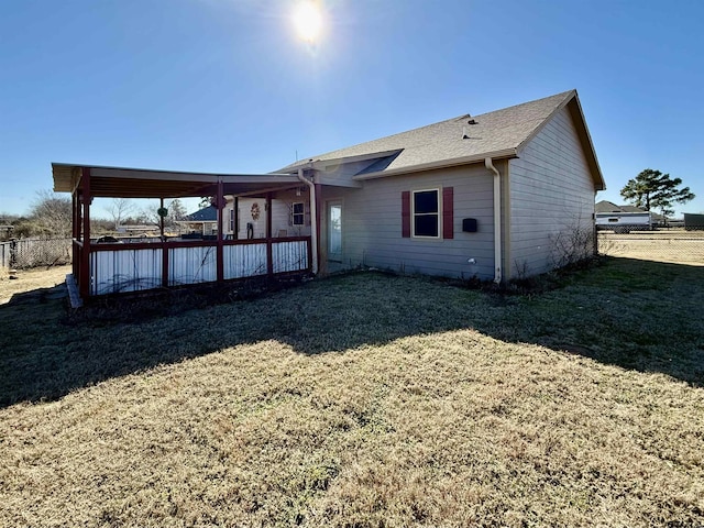 rear view of property with a yard