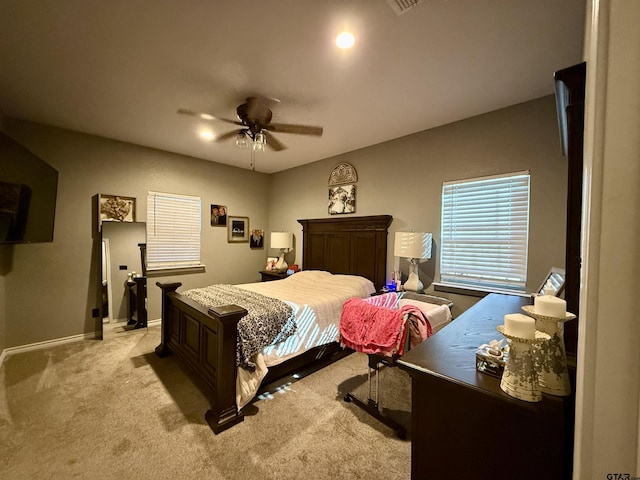 bedroom featuring light carpet and ceiling fan