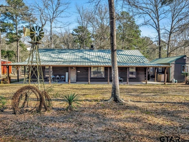 view of front of house with metal roof and log exterior