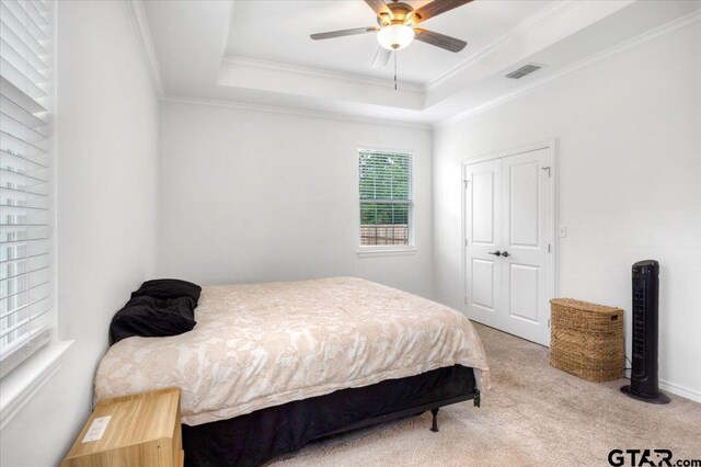 509 Zimmerman Dr, Jacksonville, TX 75766 - bedroom with a ceiling fan, visible vents, crown molding, carpet, and a tray ceiling