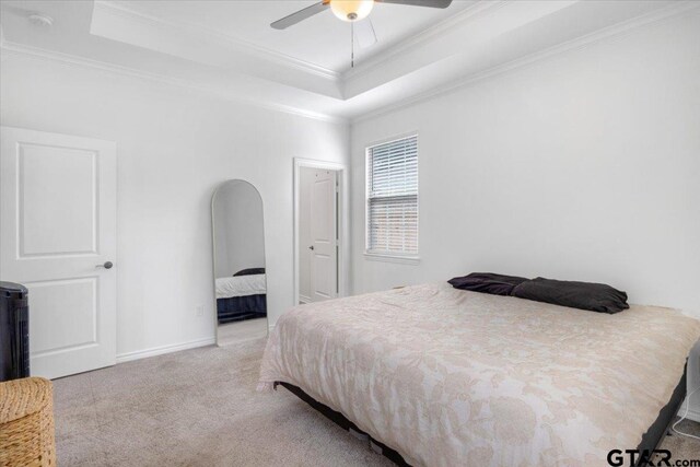509 Zimmerman Dr, Jacksonville, TX 75766 - bedroom with a raised ceiling, carpet floors, a ceiling fan, baseboards, and ornamental molding