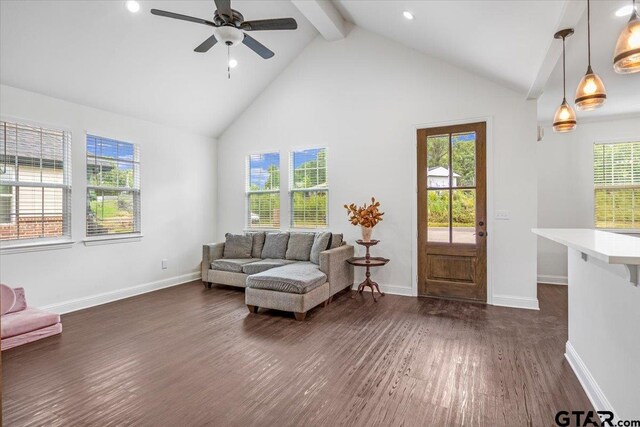 509 Zimmerman Dr, Jacksonville, TX 75766 - living room featuring beamed ceiling, dark wood-style floors, ceiling fan, and plenty of natural light
