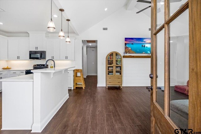 509 Zimmerman Dr, Jacksonville, TX 75766 - kitchen featuring light countertops, dark wood-style flooring, beamed ceiling, and black appliances