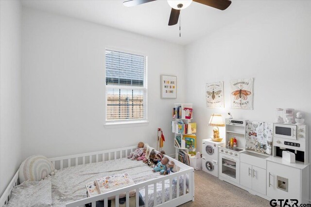 509 Zimmerman Dr, Jacksonville, TX 75766 - bedroom with light colored carpet and a ceiling fan