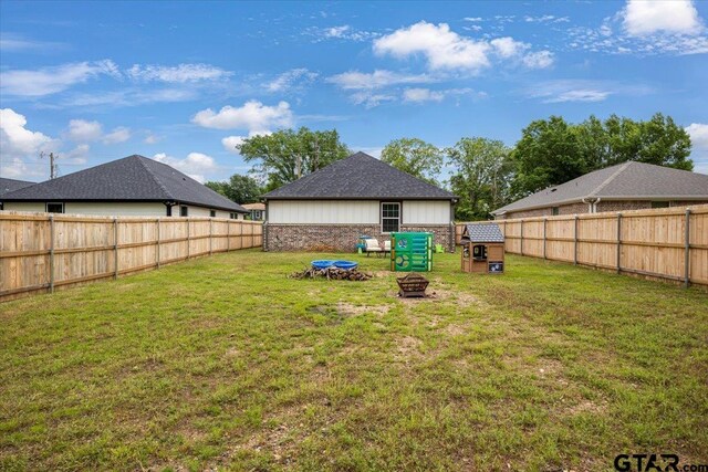 509 Zimmerman Dr, Jacksonville, TX 75766 - view of yard featuring a fenced backyard and an outdoor fire pit