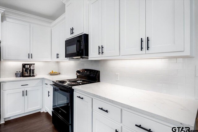 509 Zimmerman Dr, Jacksonville, TX 75766 - kitchen with dark wood-style flooring, white cabinets, light stone counters, backsplash, and black appliances