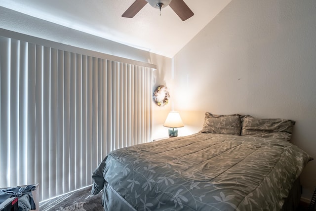 carpeted bedroom featuring ceiling fan and lofted ceiling