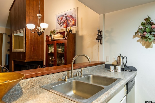 kitchen featuring a chandelier, dishwasher, and sink