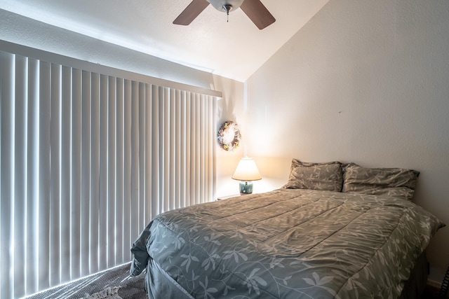 carpeted bedroom with ceiling fan and lofted ceiling