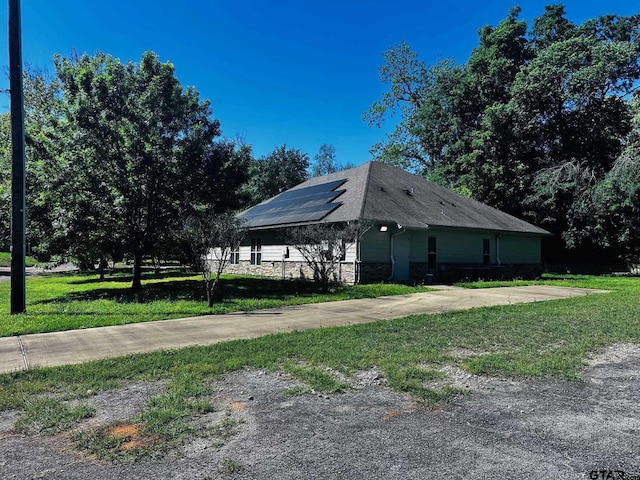 view of outbuilding with solar panels