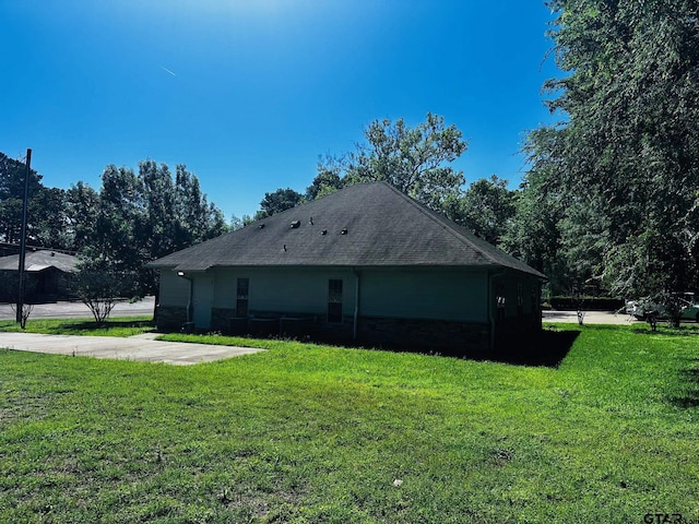 view of property exterior with a lawn