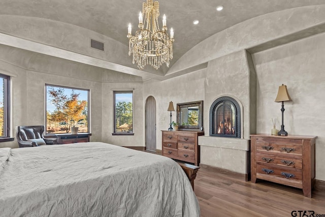 bedroom featuring vaulted ceiling and hardwood / wood-style flooring