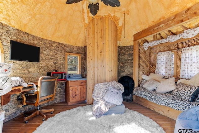 bedroom featuring a towering ceiling and hardwood / wood-style floors