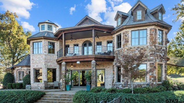 view of front of property with a balcony and french doors