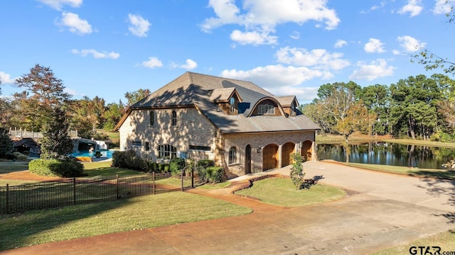 view of front of home with a water view and a front yard