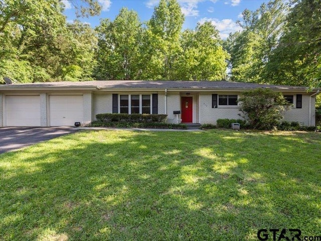415 Lakeshore Dr, Palestine, TX 75801 - ranch-style house featuring a front lawn, a garage, brick siding, and aphalt driveway