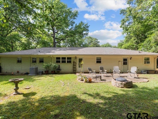 415 Lakeshore Dr, Palestine, TX 75801 - back of house with cooling unit, a patio, a lawn, and an outdoor fire pit