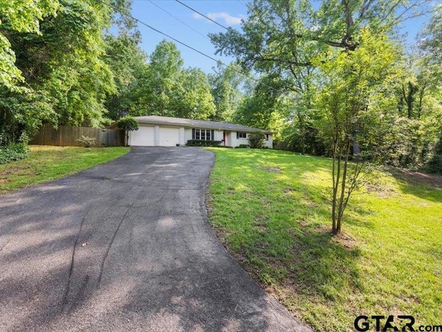 415 Lakeshore Dr, Palestine, TX 75801 - ranch-style home with a front lawn, driveway, an attached garage, and fence