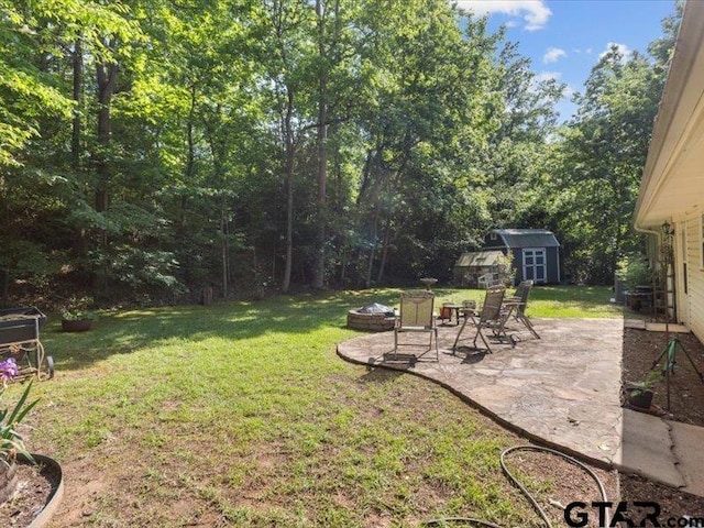415 Lakeshore Dr, Palestine, TX 75801 - view of yard featuring a patio, a fire pit, an outbuilding, and a storage shed