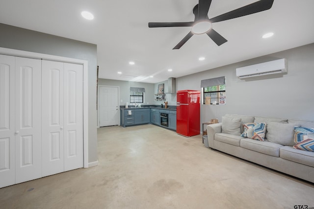 living room featuring an AC wall unit, ceiling fan, and recessed lighting