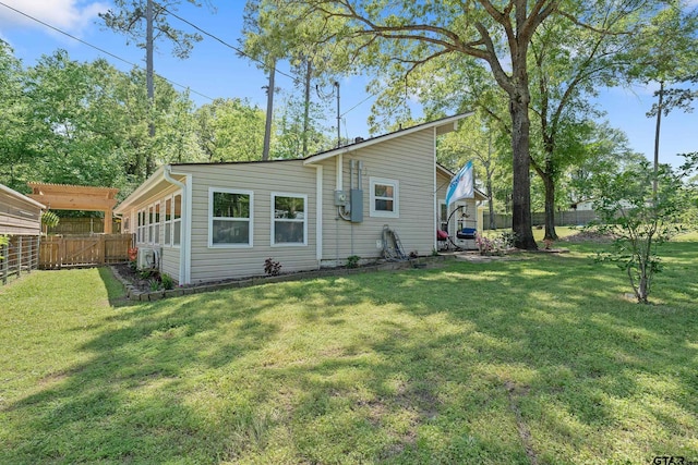 back of property with a fenced backyard and a lawn