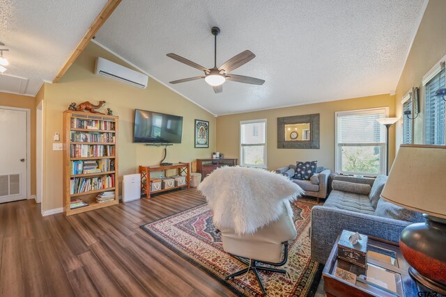 living area with a textured ceiling, a ceiling fan, a wall unit AC, lofted ceiling, and wood finished floors