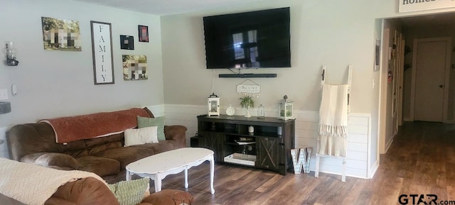 living area with wood finished floors and wainscoting