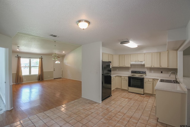 21298 Dogwood Dr, Flint, TX 75762 - kitchen with range with electric cooktop, freestanding refrigerator, under cabinet range hood, a sink, and open floor plan