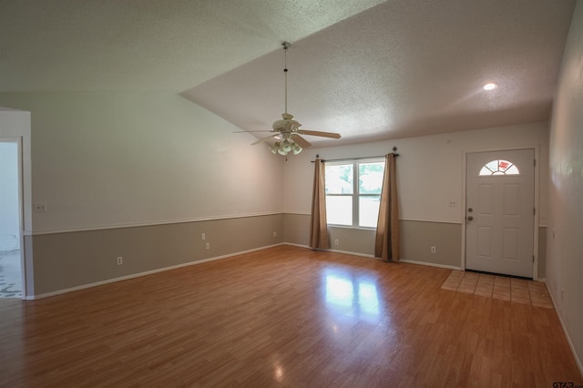 21298 Dogwood Dr, Flint, TX 75762 - unfurnished living room with wood finished floors, a ceiling fan, vaulted ceiling, baseboards, and a textured ceiling