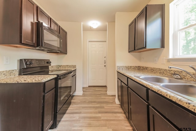 2525 N Tenneha Ave, Tyler, TX 75702 - kitchen featuring black appliances, dark brown cabinetry, light wood-type flooring, and light countertops