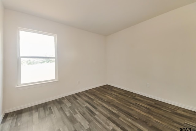 2525 N Tenneha Ave, Tyler, TX 75702 - empty room featuring dark wood finished floors and baseboards