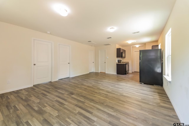 2525 N Tenneha Ave, Tyler, TX 75702 - unfurnished living room featuring wood finished floors and baseboards