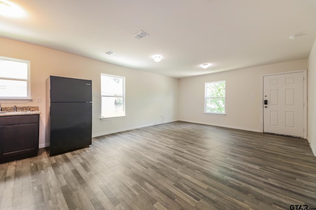 2525 N Tenneha Ave, Tyler, TX 75702 - unfurnished living room featuring dark wood-style floors