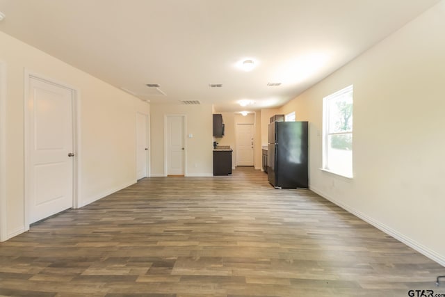 2525 N Tenneha Ave, Tyler, TX 75702 - unfurnished living room featuring dark wood-type flooring and baseboards