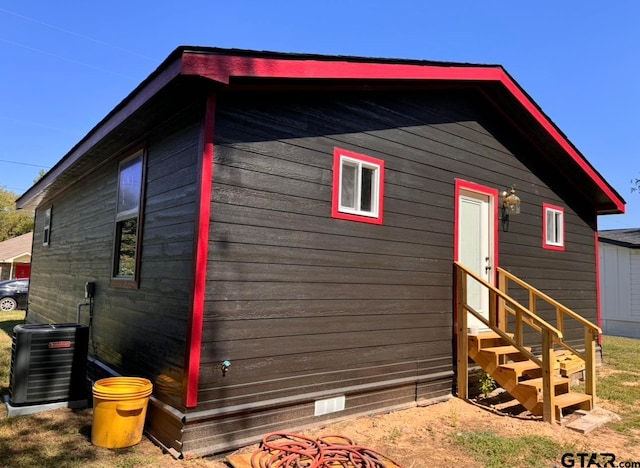 view of side of home with central air condition unit