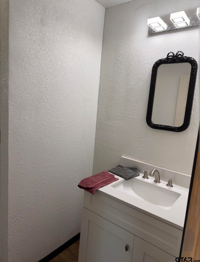 bathroom with hardwood / wood-style floors and vanity