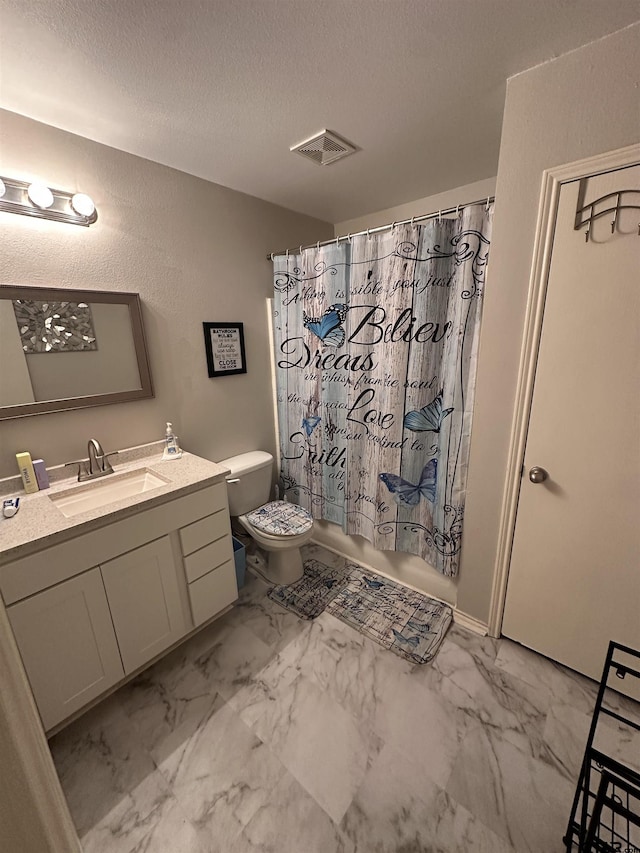 bathroom with visible vents, toilet, vanity, marble finish floor, and a textured ceiling