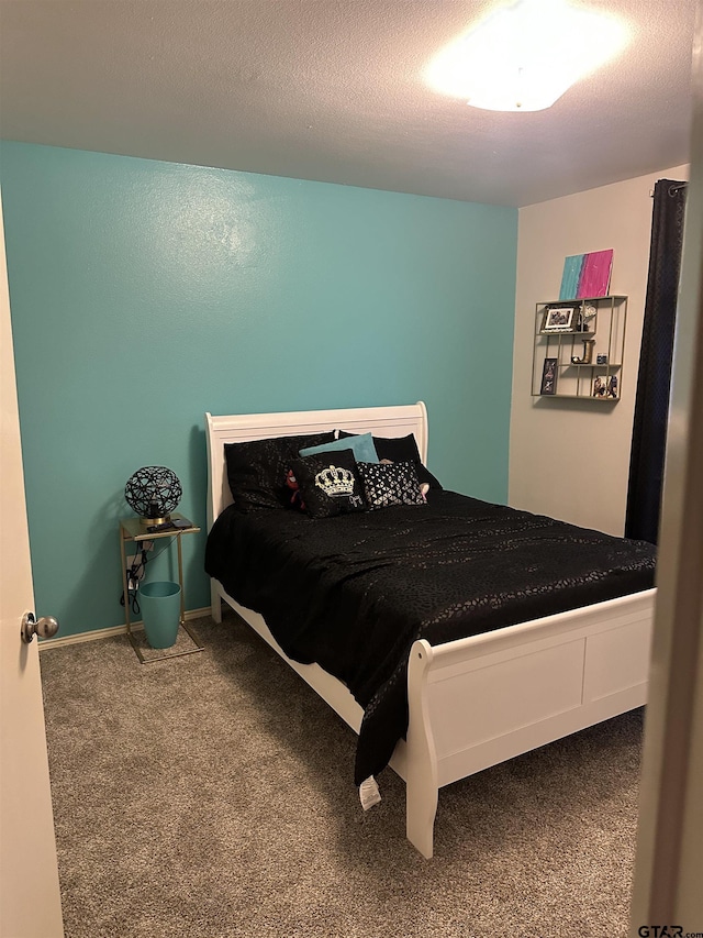 bedroom featuring carpet and a textured ceiling