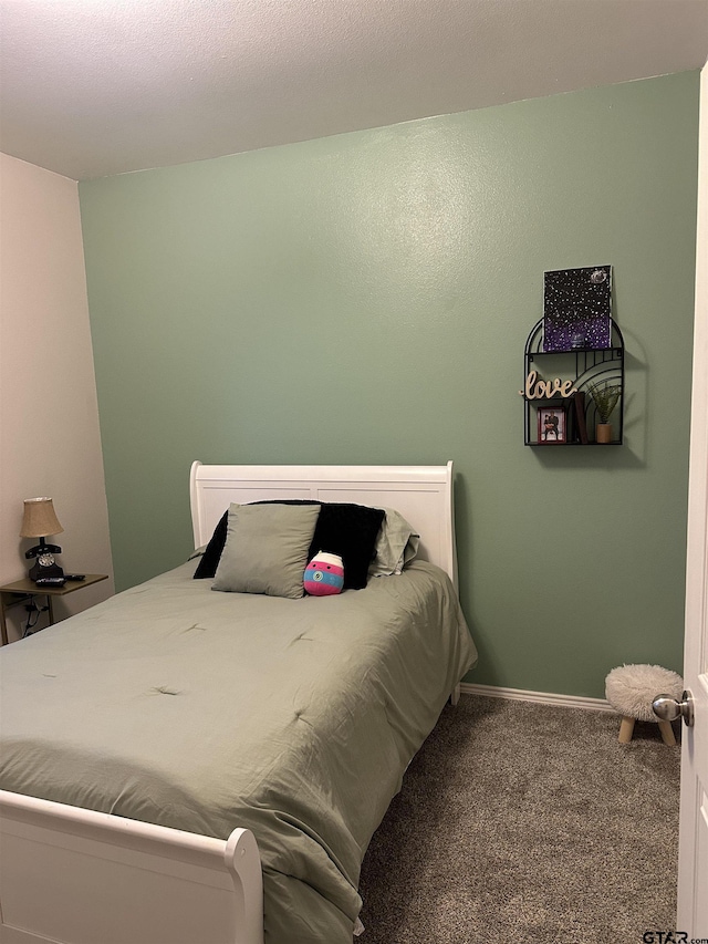 carpeted bedroom featuring baseboards