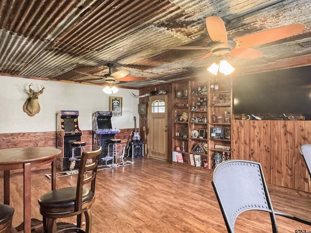 15250 Fm 858, Athens, TX 75752 - dining room featuring ceiling fan, wood walls, a wainscoted wall, and wood finished floors
