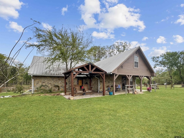 15250 Fm 858, Athens, TX 75752 - rear view of property featuring stone siding, metal roof, and a lawn