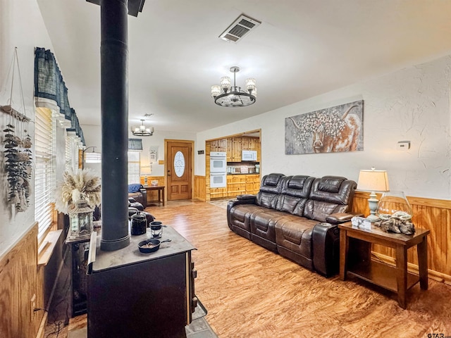 15250 Fm 858, Athens, TX 75752 - living room with a chandelier, wood finished floors, wainscoting, and wood walls