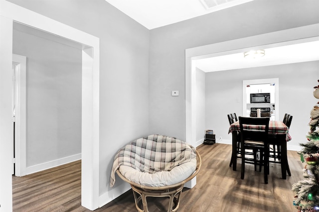 dining space featuring dark hardwood / wood-style flooring