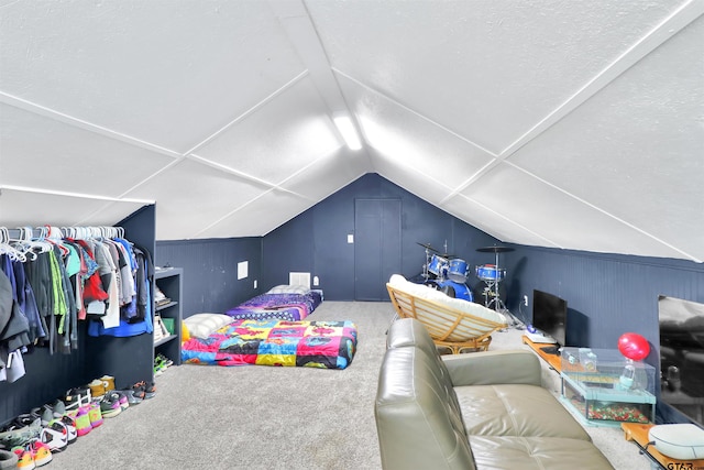 bedroom with carpet floors and lofted ceiling