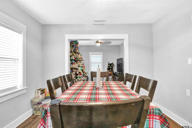 dining space with hardwood / wood-style flooring and ceiling fan