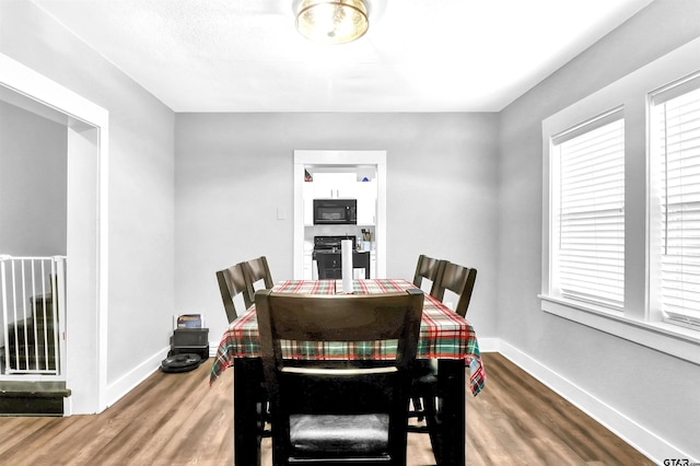 dining space with hardwood / wood-style floors and a wealth of natural light