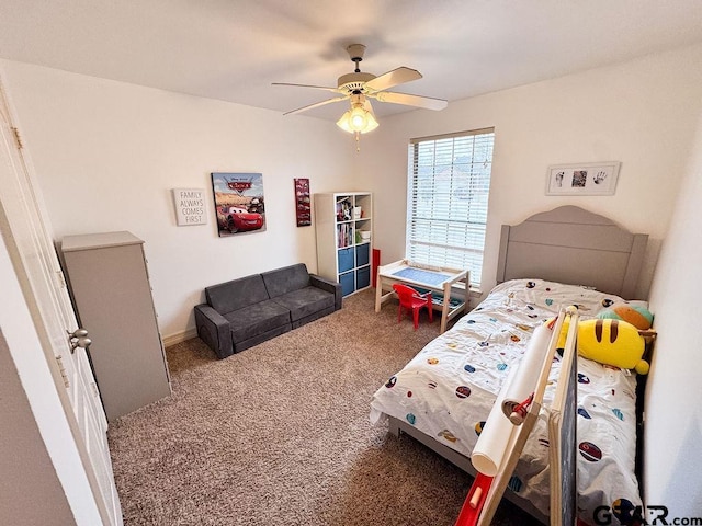 carpeted bedroom featuring baseboards and a ceiling fan